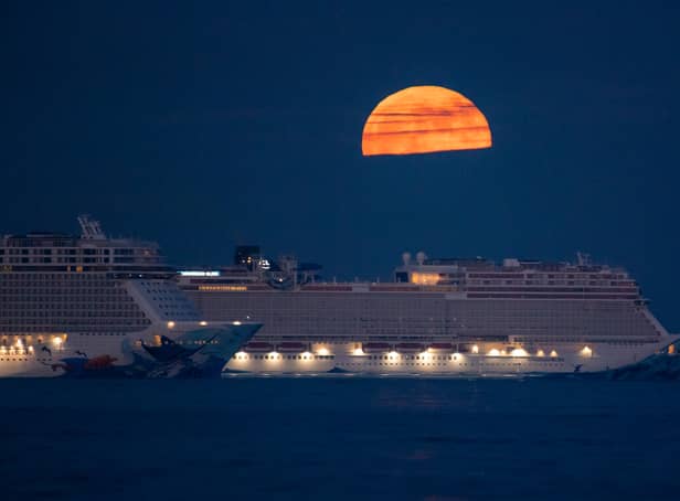 <p>The Flower Moon rises over the cruise ships Norwegian Escape and Norwegian Bliss in the bay</p>