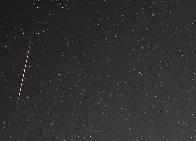 A close-up view shows a meteor streaking across the sky as the Earth passes through the debris trails of a broken comet earlier this year.