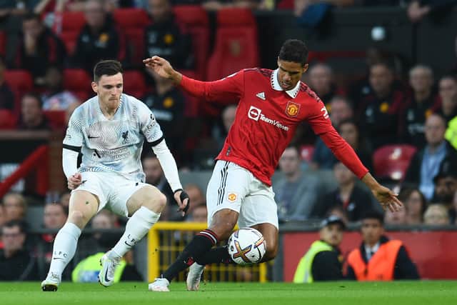 Andy Robertson challenges Manchester United star Raphael Varane (Photo by Andrew Powell/Liverpool FC via Getty Images)