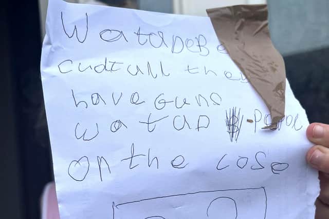 One little girl approached our reporter and handed her this note: “Want to be careful, they have guns. Watch out on the close.” Image: Emma Dukes