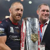 James Roby of St Helens holds the Grand Final Trophy with Kristian Woolf, Head Coach after victory in the Betfred Super League Grand Final match between Catalans Dragons and St Helens at Old Trafford on October 09, 2021 in Manchester, England. (Photo by Lewis Storey/Getty Images)