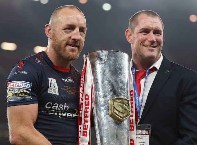 James Roby of St Helens holds the Grand Final Trophy with Kristian Woolf, Head Coach after victory in the Betfred Super League Grand Final match between Catalans Dragons and St Helens at Old Trafford on October 09, 2021 in Manchester, England. (Photo by Lewis Storey/Getty Images)
