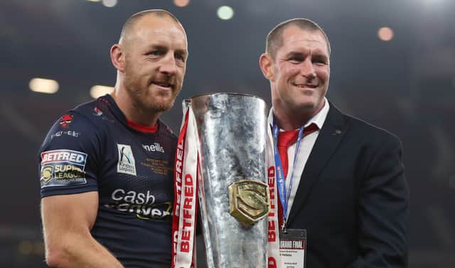 <p>James Roby of St Helens holds the Grand Final Trophy with Kristian Woolf, Head Coach after victory in the Betfred Super League Grand Final match between Catalans Dragons and St Helens at Old Trafford on October 09, 2021 in Manchester, England. (Photo by Lewis Storey/Getty Images)</p>