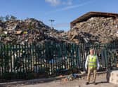 Jeremy Poupard, the manager at MST Group, standing in front of the rubbish pile next door. Credit: Liverpool Echo.