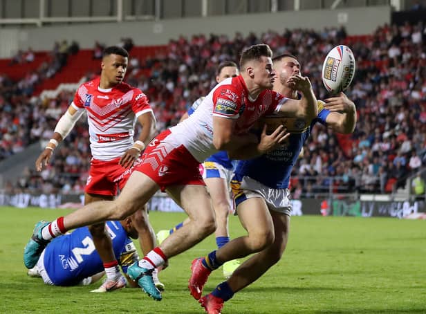 <p>Jack Welsby of St Helens battles for possession with James Bentley of Leeds Rhinos during the Betfred Super League between St Helens and Leeds Rhinos at Totally Wicked Stadium on June 23, 2022</p>