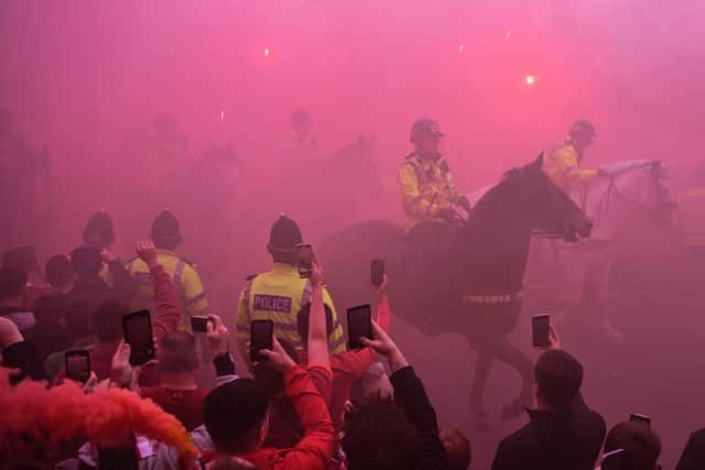 Police officers patrol on their horses prior to the arrival of the Liverpool's team bus prior to the English Premier League football match between Liverpool and Wolverhampton Wanderers at Anfield in Liverpool,