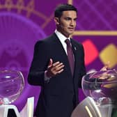 Former Australian footballer Tim Cahill speaks on stage during the draw for the 2022 World Cup in Qatar at the Doha Exhibition and Convention Center 