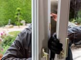 A burglar tries to break in an open window with a crowbar. Image: Gina Sanders - stock.adobe.com