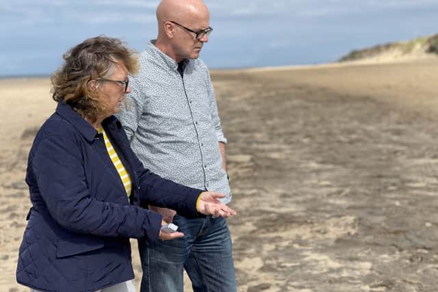 Dr Alison Burns and Professor Jamie Woodward inspecting 8500-year-old animal and human footprints in one of the Mesolithic mud beds at Formby. Image: Jamie Woodward/SWNS