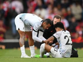 Luis Diaz of Liverpool receives medical treatment before being substituted off during the Premier League match between Arsenal FC and Liverpool FC at Emirates Stadium on October 09, 2022 in London, England. (Photo by Shaun Botterill/Getty Images)