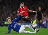 Bruno Fernandes is tackled by Anthony Gordon during the Premier League match between Everton and Manchester United (Photo by Clive Brunskill/Getty Images)