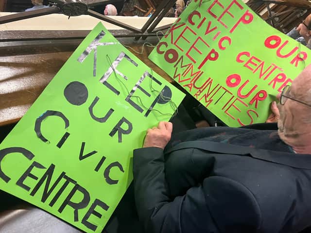 Protest signs in support of keeping Bromborough civic centre open at the full council meeting on October 10. Credit: Ed Barnes