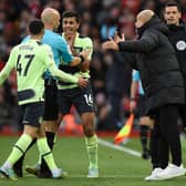 Manchester City manager Pep Guardiola and his players surround referee Anthony Taylor as he goes to the screen to look at a VAR review ahead of his disallowing Phil Foden’s goal (Photo by OLI SCARFF/AFP via Getty Images)
