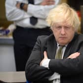 Boris Johnson speaks with members of the Metropolitan Police in their break room, as he makes a constituency visit to Uxbridge police station on December 17, 2021 in Uxbridge, England. (Photo by Leon Neal/Getty Images)