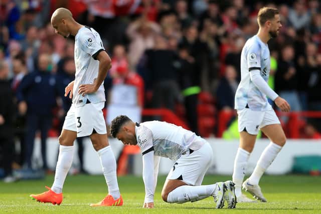 Liverpool midfielders Fabinho, Alex Oxlade-Chamberlain and Jordan Henderson react to the loss at Nottingham Forest. Picture:  LINDSEY PARNABY/AFP via Getty Images