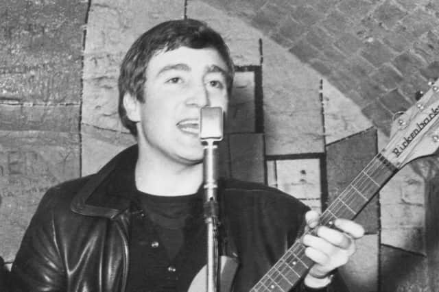 Singer, guitarist and songwriter John Lennon (1940 - 1980) of the British group The Beatles live on stage at the Cavern Club in Matthew Street, Liverpool.  (Photo by Evening Standard/Hulton Archive/Getty Images)