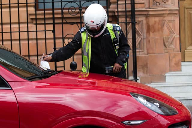 A traffic warden issues a parking ticket. Image: Carl Court/Getty Images