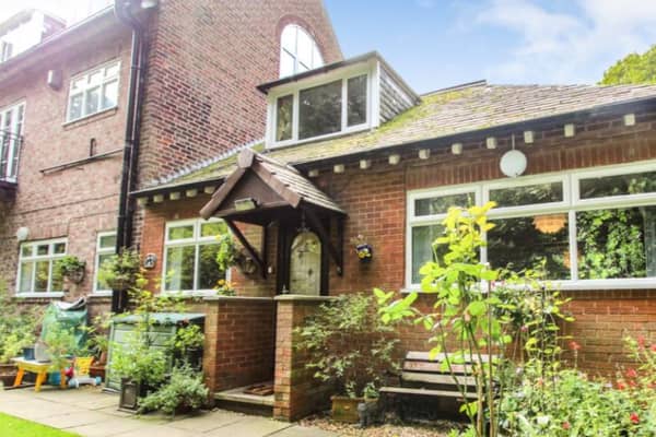The three-bed property has a cottage like feel, surrounded by shrubbery.