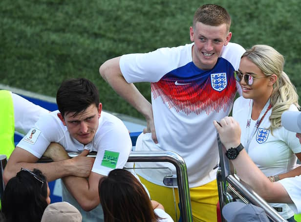 <p>England's goalkeeper Jordan Pickford (C) and his partner Megan Davison (R) celebrate after the Russia 2018 World Cup Group G football match between England and Panama at the Nizhny Novgorod Stadium in Nizhny Novgorod on June 24, 2018. (Photo by Johannes EISELE / AFP) / RESTRICTED TO EDITORIAL USE - NO MOBILE PUSH ALERTS/DOWNLOADS        (Photo credit should read JOHANNES EISELE/AFP via Getty Images)</p>