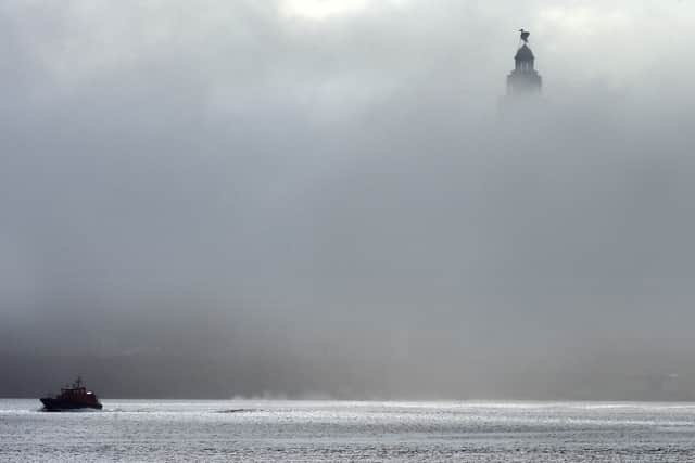 A pilot boat passes the Liver Building in Liverpool, north-west England on April 07, 2015 as fog covers the River Mersey. AFP PHOTO/PAUL ELLIS        (Photo credit should read PAUL ELLIS/AFP via Getty Images)