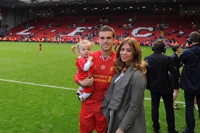 Jordan Henderson of Liverpool with his wife and child at the end of the Barclays Premier League match between Liverpool and Newcastle United at Anfield on May 11, 2014 in Liverpool, England.  (Photo by Andrew Powell/Liverpool FC via Getty Images)