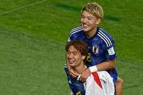 Japan celebrate their win over Spain in final Group E match