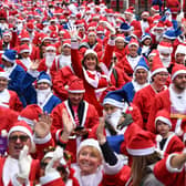 Runners dressed in Father Christmas attire prepare to take part in the annual five-kilometre Santa Dash in Liverpool. (Photo by OLI SCARFF/AFP via Getty Images)