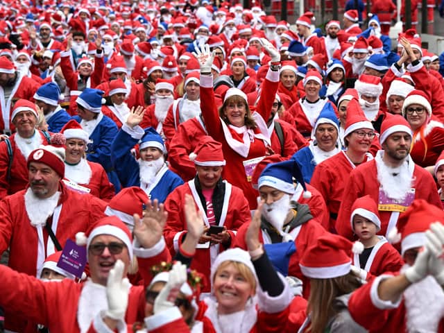 Runners dressed in Father Christmas attire prepare to take part in the annual five-kilometre Santa Dash in Liverpool. (Photo by OLI SCARFF/AFP via Getty Images)