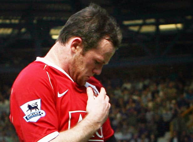 <p>Wayne Rooney kisses the Manchester United badge after scoring against Everton in 2007. Picture: PAUL ELLIS/AFP via Getty Images</p>