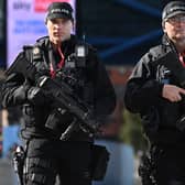 An armed police patrol. Image: OLI SCARFF/AFP via Getty Images