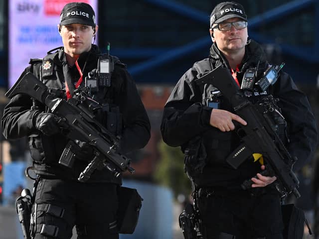 An armed police patrol. Image: OLI SCARFF/AFP via Getty Images
