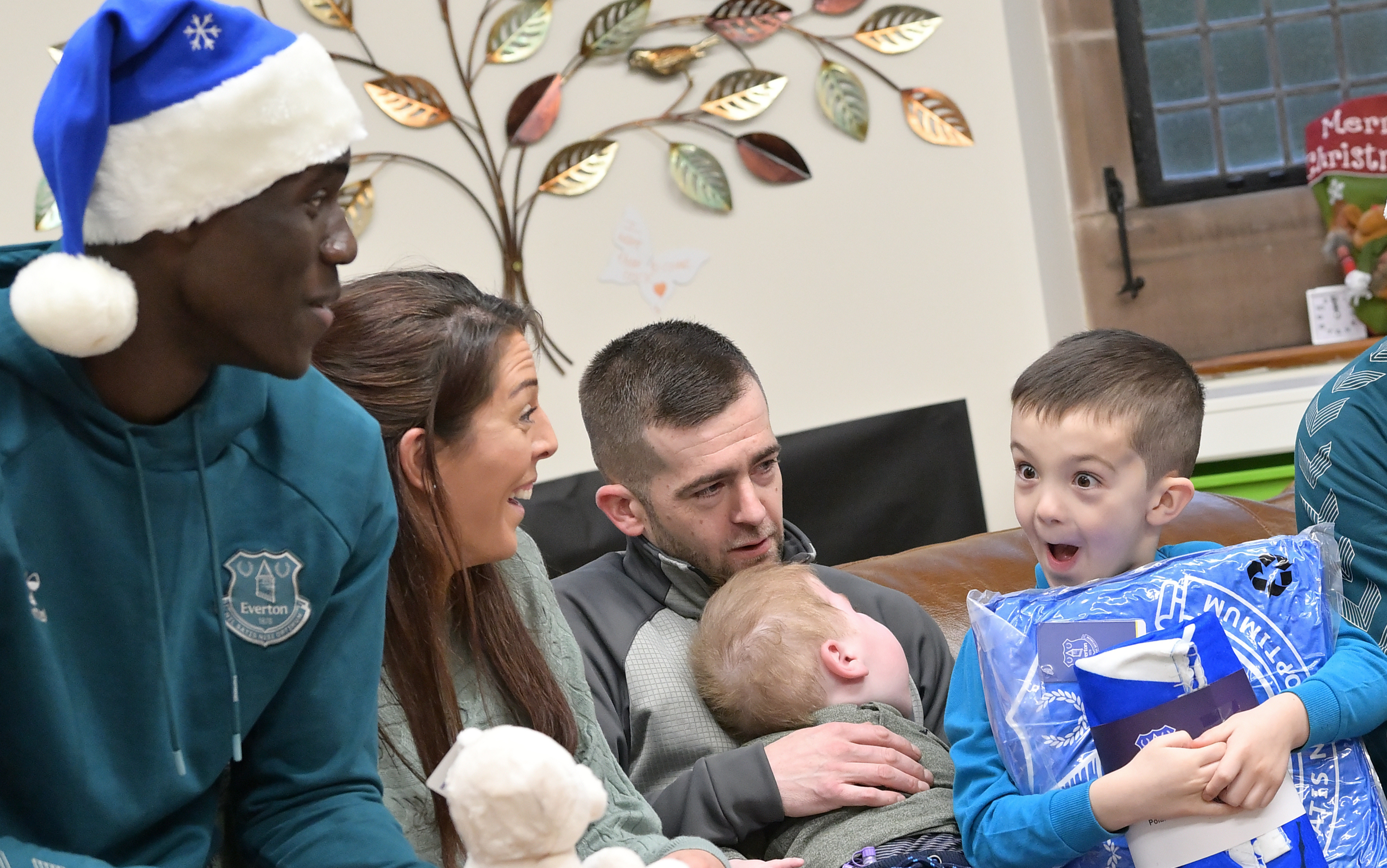 Everton stars don Santa hats to spread Christmas cheer to ill children
