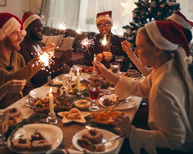 Multi-ethnic group of people enjoying Christmas dinner at home
