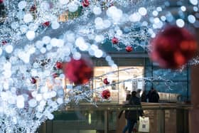 Shoppers walk among the Christmas lights at Liverpool ONE in 2017. Photo by Christopher Furlong/Getty Images