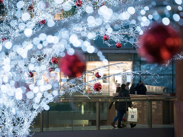 Shoppers walk among the Christmas lights at Liverpool ONE in 2017. Photo by Christopher Furlong/Getty Images