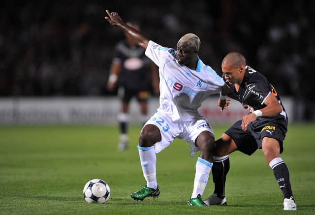 (FILES) In this file photo taken on September 13, 2008 Girondin’s forward Yoan Gouffran (R) fights for the ball with with Marseille’s Cameroonian midfielder Modeste M’ Bami during the French L1 football match between Bordeaux and Olympique de Marseille, at the Chaban Delmas stadium in Bordeaux, southwestern France. - Cameroonian Modeste M’Bami, former midfielder for Paris Saint-Germain and Olympique de Marseille died aged 40 in Le Havre, announces sports agent Frank Belhassen, on January 7, 2023. (Photo by PIERRE ANDRIEU / AFP) (Photo by PIERRE ANDRIEU/AFP via Getty Images)