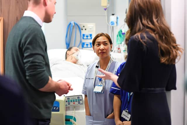 William and Kate meet health care assistant Anne O’Hara (centre) in the intensive care ward during a visit to the Royal Liverpool University Hospital 