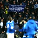 Everton fans display banners protesting against the board.