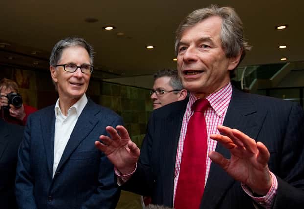 Liverpool owner John Henry, left, with Sir Martin Broughton after purchasing the Reds in 2010. Picture: Carl Court/AFP via Getty Images