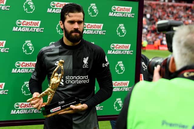 Alisson Becker of Liverpool with the Golden Glove award at the end of the Premier League match between Liverpool and Wolverhampton Wanderers at Anfield on May 22, 2022 in Liverpool, England. (Photo by Andrew Powell/Liverpool FC via Getty Images)