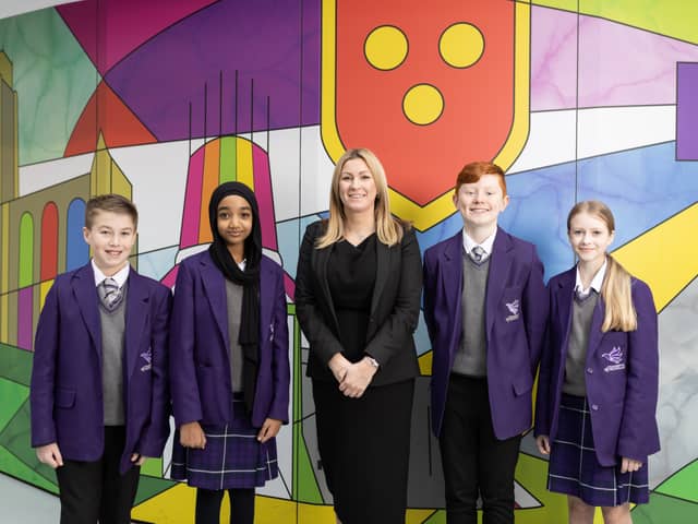 Headteacher Jeniffer Sing with students from The Academy of St Nicholas.