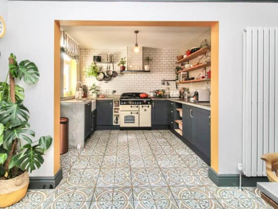The property has an incredible kitchen diner, with quirky tiles and vertical radiators. 