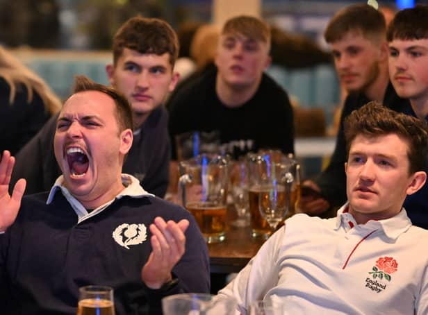 <p>A Scotland fan celebrates while surrounded by England fans during the Scotland v England at the Bambalan bar on February 5, 2022 in Bristol, England. </p>