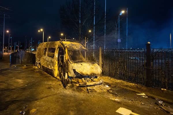 A burnt out police van after a demonstration outside the Suites Hotel in Knowsley, Merseyside. Picture: PA
