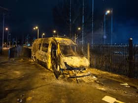 A burnt out police van after a demonstration outside the Suites Hotel in Knowsley, Merseyside. Picture: PA
