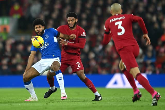 Ellis Simms of Everton is challenged by Joe Gomez of Liverpool during the Premier League match between Liverpool FC and Everton FC at Anfield on February 13, 2023 in Liverpool, England. (Photo by Michael Regan/Getty Images)