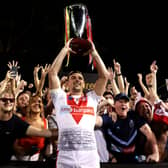 Lewis Dodd of the Saints holds aloft the World Club Challenge trophy with fans after victory against Penrith Panthers. Image: Mark Metcalfe/Getty Images