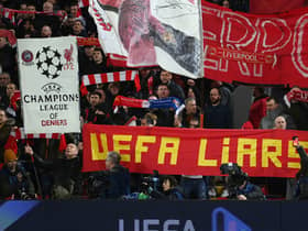 A general view as fans of Liverpool in the Kop End hold banners which read "Champions League of Diniers" and "UEFA Liars" prior to the UEFA Champions League round of 16 leg one match between Liverpool FC and Real Madrid at Anfield on February 21, 2023 in Liverpool, England. (Photo by Michael Regan/Getty Images)