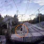 The video shows a man just inches from being hit by the speeding train.