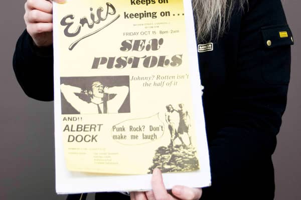 Claire Howell, music memorabilia consultant at Hansons Auctioneers, with the Sex Pistols poster. Image: Hansons / SWNS